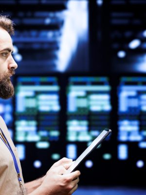 Developer installs server hub firewalls IT developer setting up high tech data center firewalls, intrusion detection systems and doing security updates. Cybersecurity employee preventing hacking, malware, and DDoS attacks in server hub